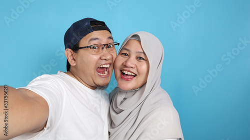 Happy Asian Muslim Couple Making Selfie