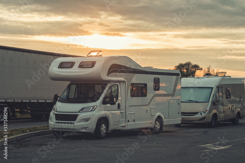 sunrise with campervan mobile home campervan fuels in gas station for an outdoor nomad lifestyle camper van caravan vehicle for van life holiday on motor home journey camping in the parking © Damian