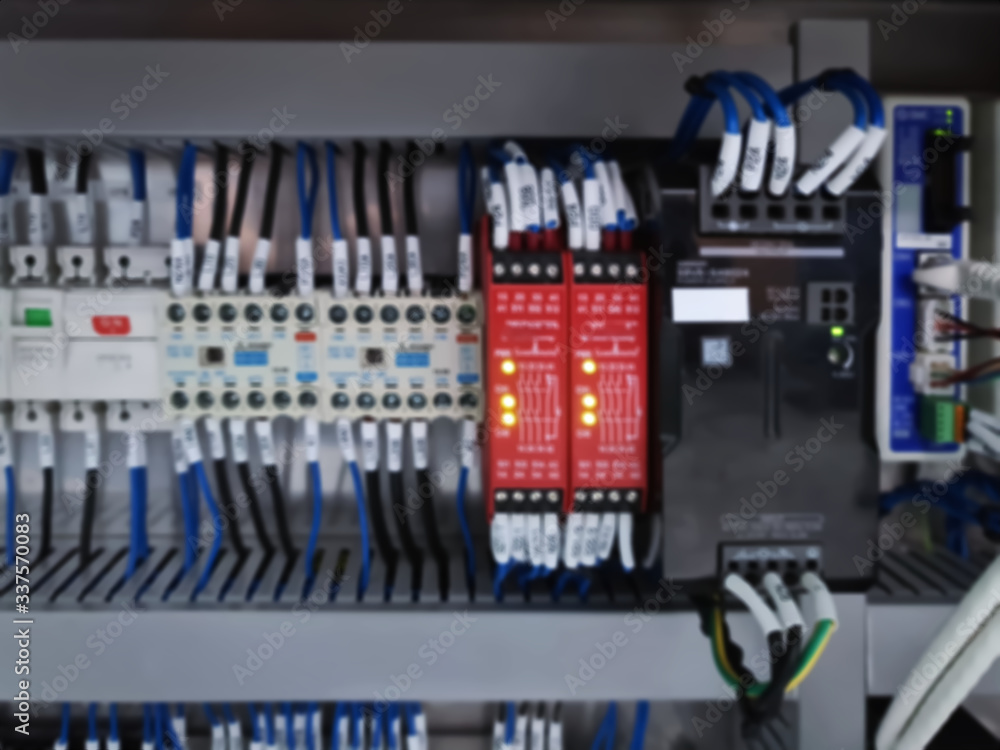 Blurred Background of Switches and Wiring Inside of Electrical Control Cabinet