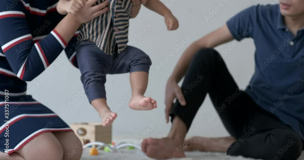 Happy family with toddler boy playing at home white wall. Family sitting on floor and playing together. Happy family with toddler boy playing at home white wall. Family sitting on floor and playing together.