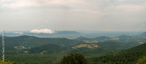 Hazy Rolling Hills Forest and Valley After Rain with Single Low White Cloud