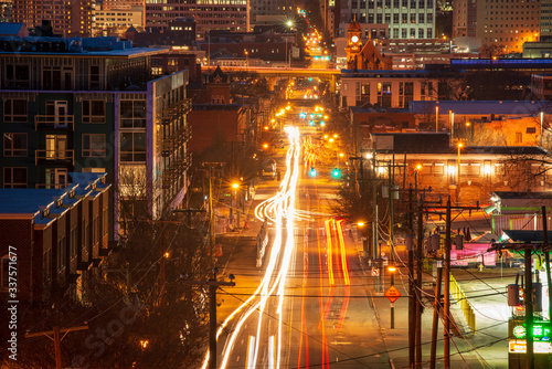 Fotografía Car light trails in city streets at night, Main Street in Downtown Richmond, Cen