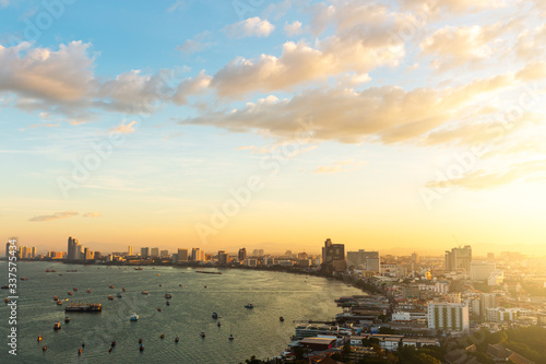 Pattaya city in the sunrise. The golden light of the sun shining on the right side.
