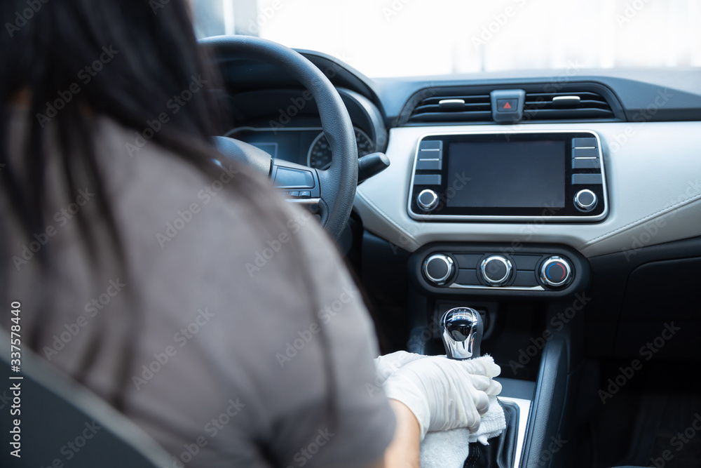 Person's hands with gloves cleaning inside a car due to coronavirus pandemic in Mexico Person's hands with gloves cleaning inside a car due to coronavirus pandemic in Mexico
