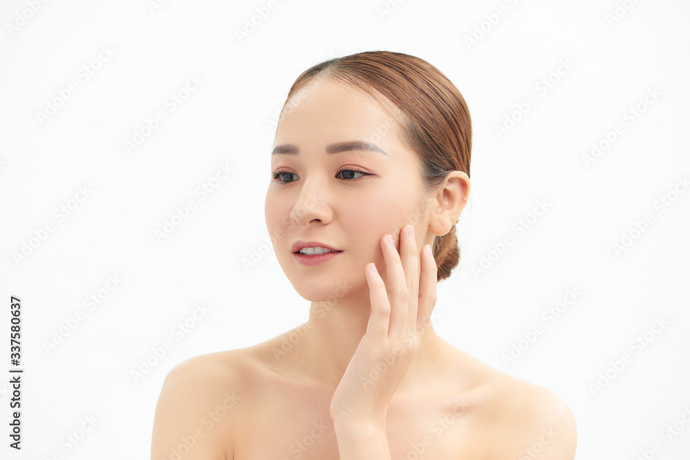 Young woman touching her face isolated on white background Young woman touching her face isolated on white background