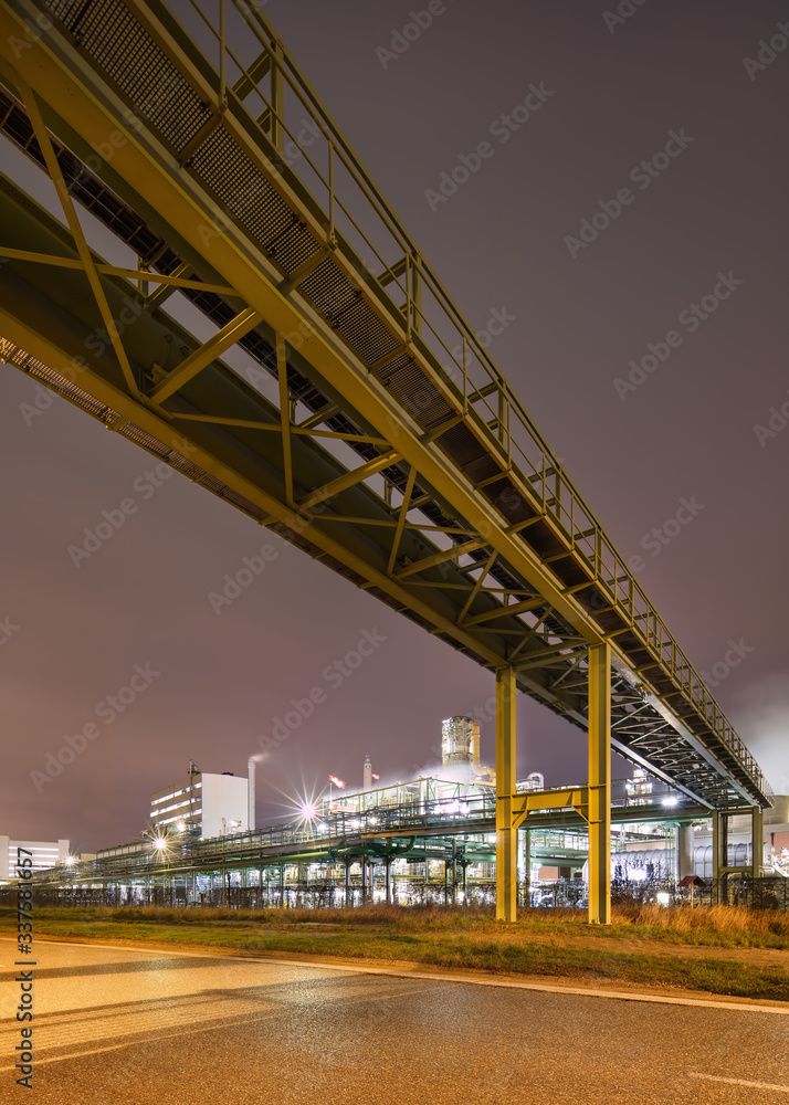 Night scene with illuminated petrochemical production plant and pipeline overpass, Antwerp, Belgium. Night scene with illuminated petrochemical production plant and pipeline overpass, Antwerp, Belgium.