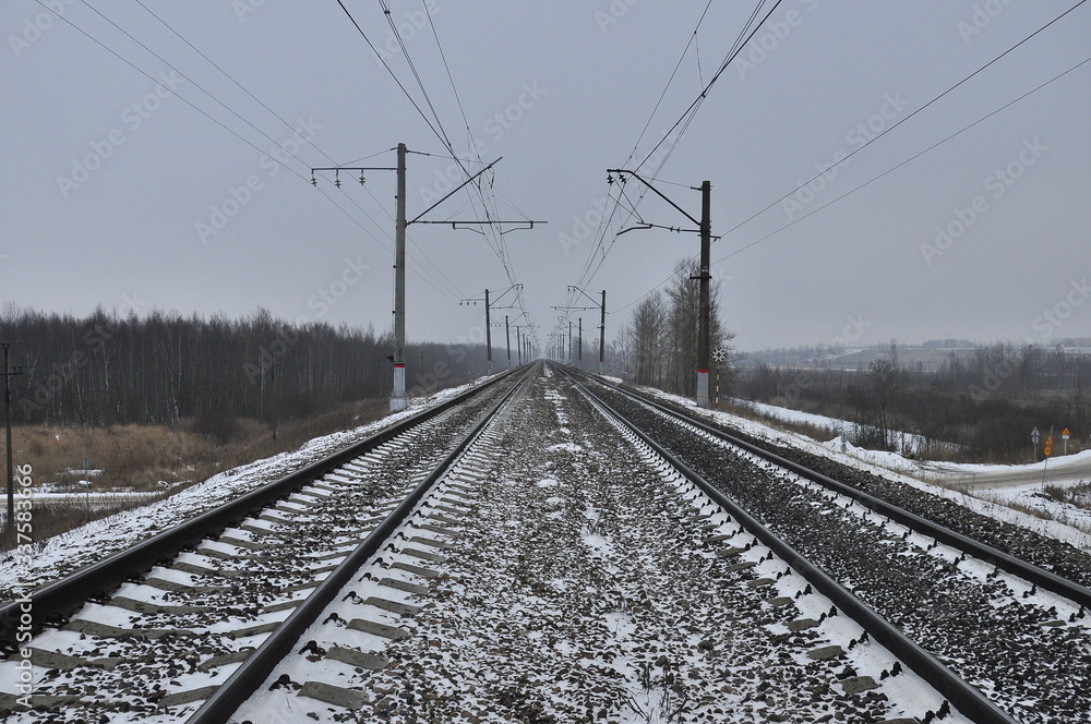 Snow covered rails that go beyond the horizon Snow covered rails that go beyond the horizon