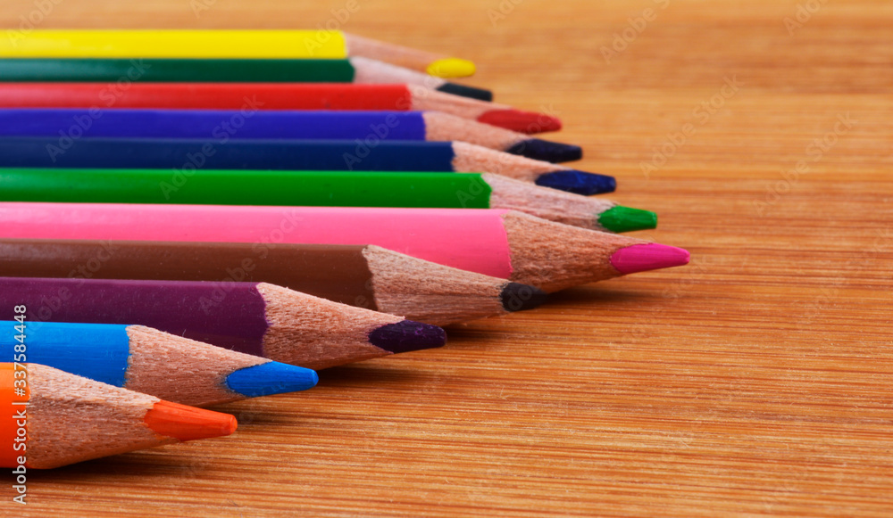 Colourful pencils on a wooden background Colourful pencils on a wooden background