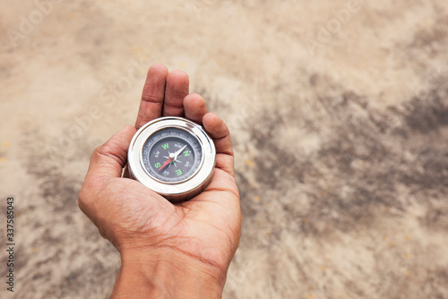 Hand holding Compass for finding direction