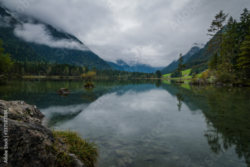 The scenic lake Hintersee in Berchtesgaden, Germany with misty alpine mountains in the background