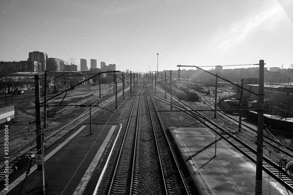 Empty railroad tracks at dawn. Black and white.
