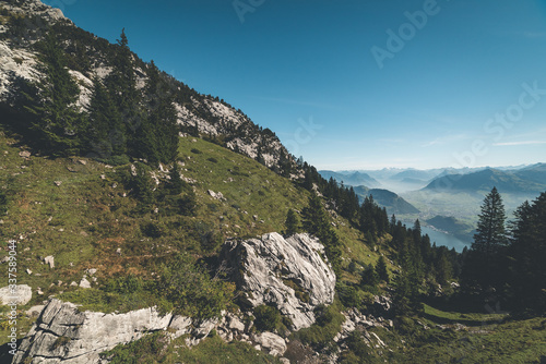 Scenic view of steep rocky mountains and grassy slopes high up in the alps on Mount Pilatus in Lucerne, Switzerland 
