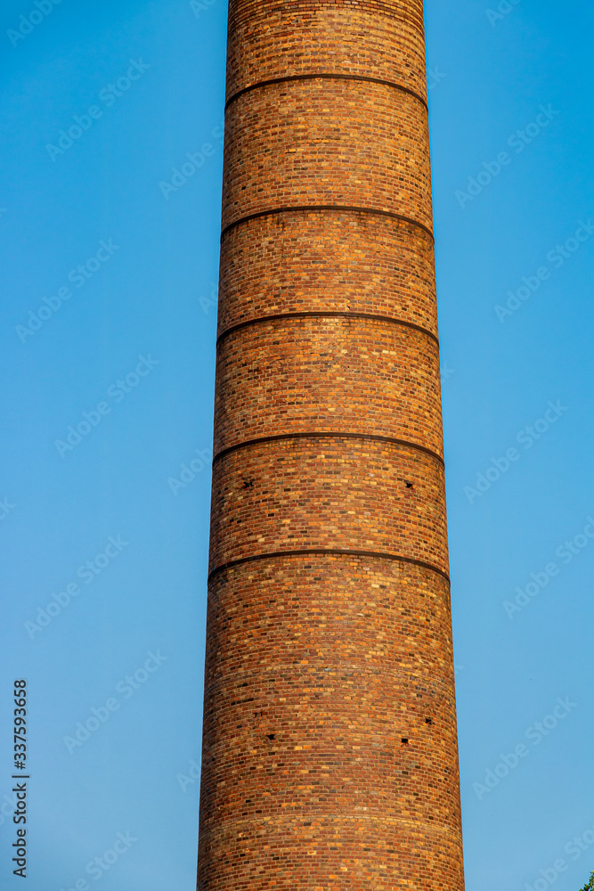 Big chimney composed of yellow brick..