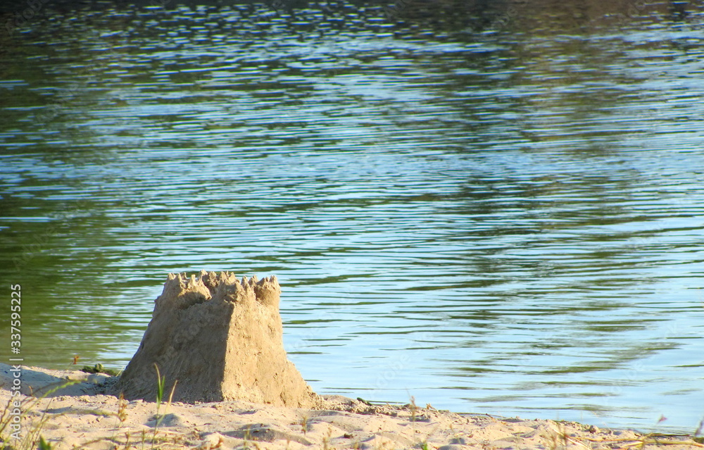 Sand castle on the shore of a pond Sand castle on the shore of a pond