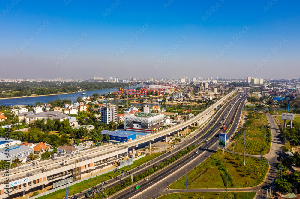 Fototapeta Top view aerial of Ha Noi highway view from district 2 to district 9, Ho Chi Minh City with development buildings, transportation, infrastructure, Vietnam.