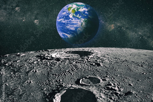 Moon limb with Earth rising on the horizon.Earth rises above lunar horizon. Elements of this image furnished by NASA.