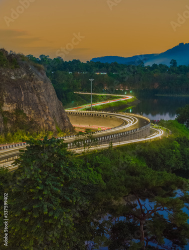 highway light trails of vehicles during rush hour and sunset photo