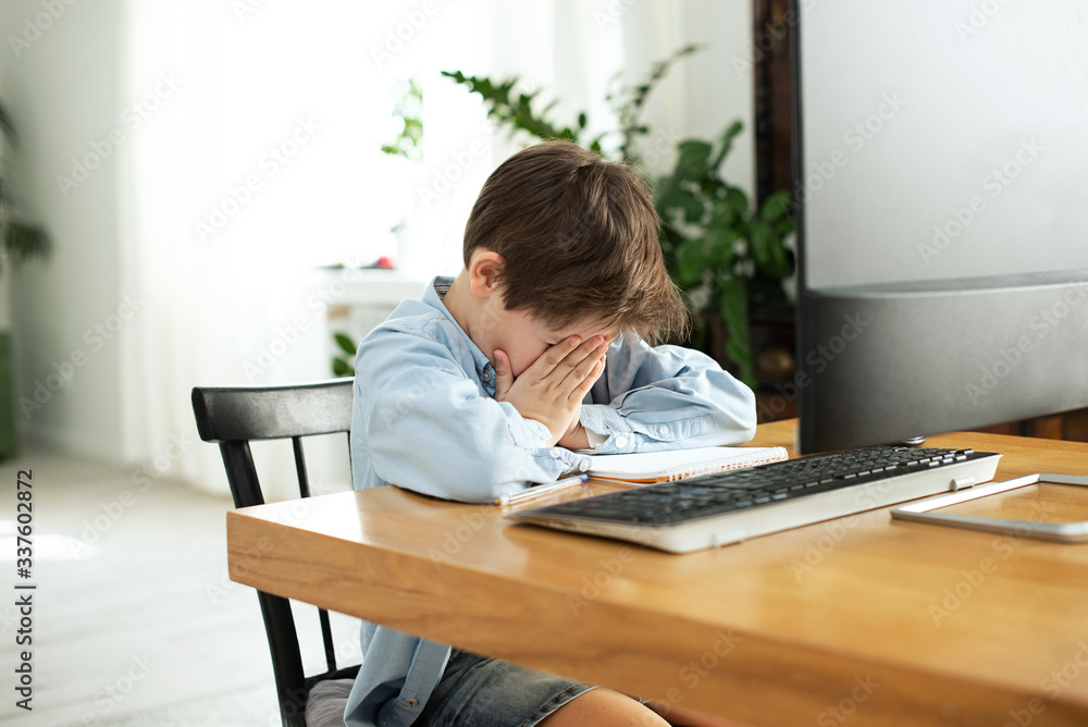 Kids and gadgets. Distance learning during isolation during quarantine in coronavirus. Boy and laptop at home. Lifestyle. Lockdown and Social Distancing Kids and gadgets. Distance learning during isolation during quarantine in coronavirus. Boy and laptop at home. Lifestyle. Lockdown and Social Distancing
