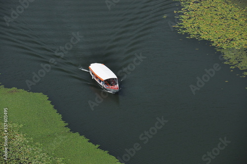 Rijeka Crnojevića, part of the Skadar Lake in Montenegro. Tourist cruises by boat on the beautiful meanders of the river flowing between the hills. photo