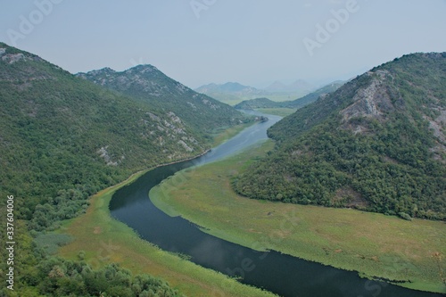 Rijeka Crnojevi  a  part of the Skadar Lake in Montenegro. Tourist cruises by boat on the beautiful meanders of the river flowing between the hills.