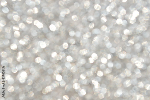 The bokeh of the patterned surface of the silver glitter plate.
