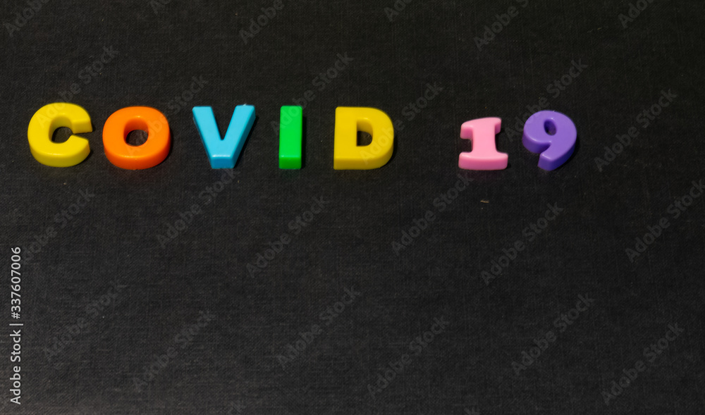 Concept of Covid-19 with alphabets words on black background Concept of Covid-19 with alphabets words on black background