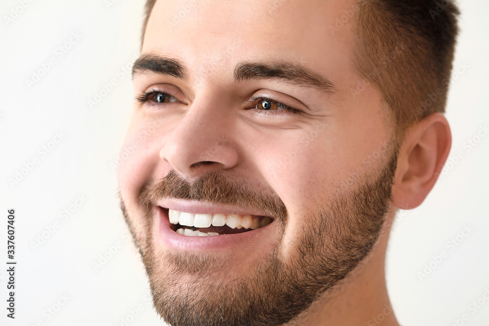 Obraz premium Handsome smiling young man on white background