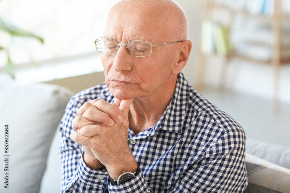 Portrait of praying elderly man at home Portrait of praying elderly man at home