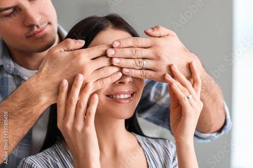 Young man covering eyes of ...
