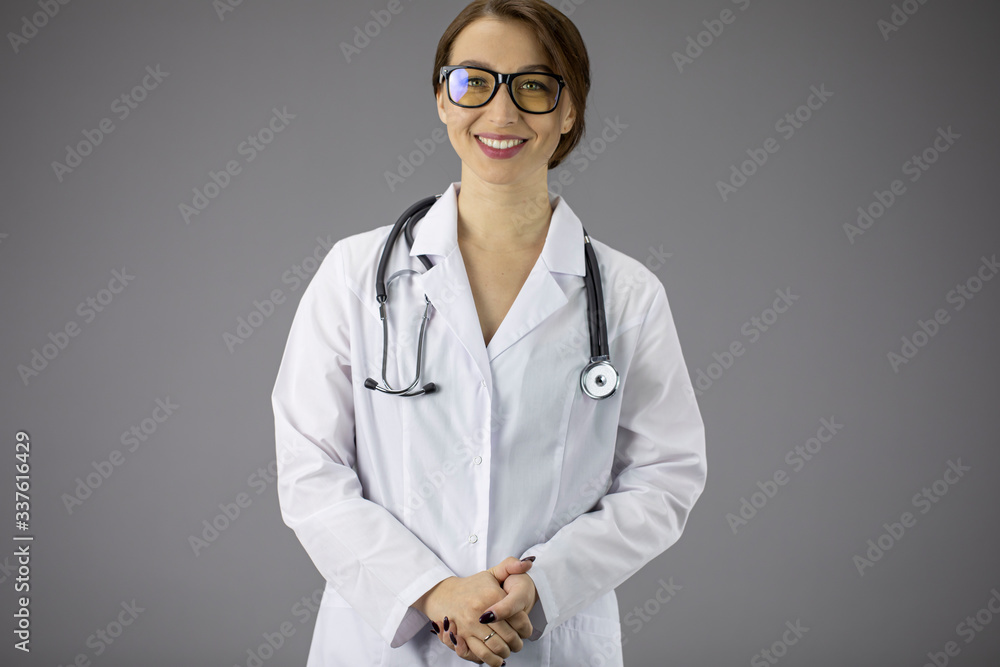 Portrait of an attractive sexy doctor woman in a white medical coat with a  stethoscope on