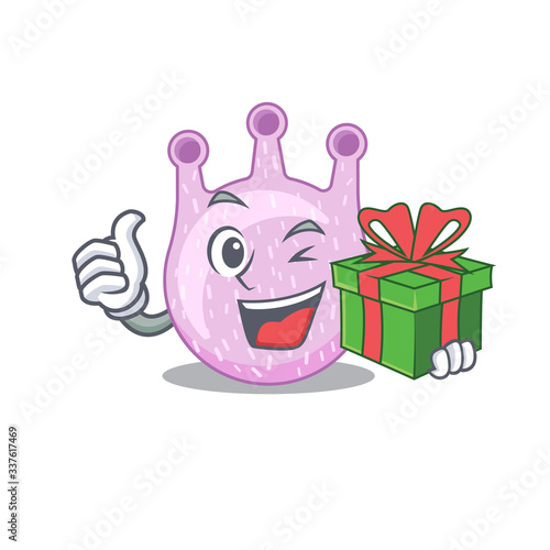 Smiling viridans streptococci cartoon character having a green gift box
