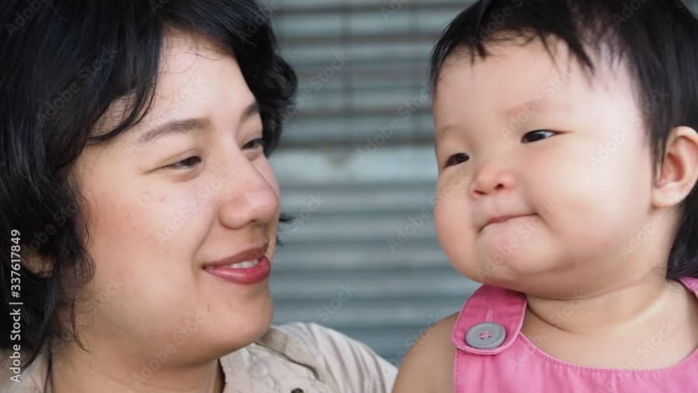 Close up cute asian infant baby girl with pretty asian woman with happy emotion.Concept is family,mother and daughter. Close up cute asian infant baby girl with pretty asian woman with happy emotion.Concept is family,mother and daughter.