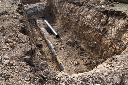 Wallpaper Mural repair and replacement main pipeline of heating systems, district heating pipes network, water supply or Sewerage in city, removing old pipes and replacing them with new ones in a hole in the ground Torontodigital.ca