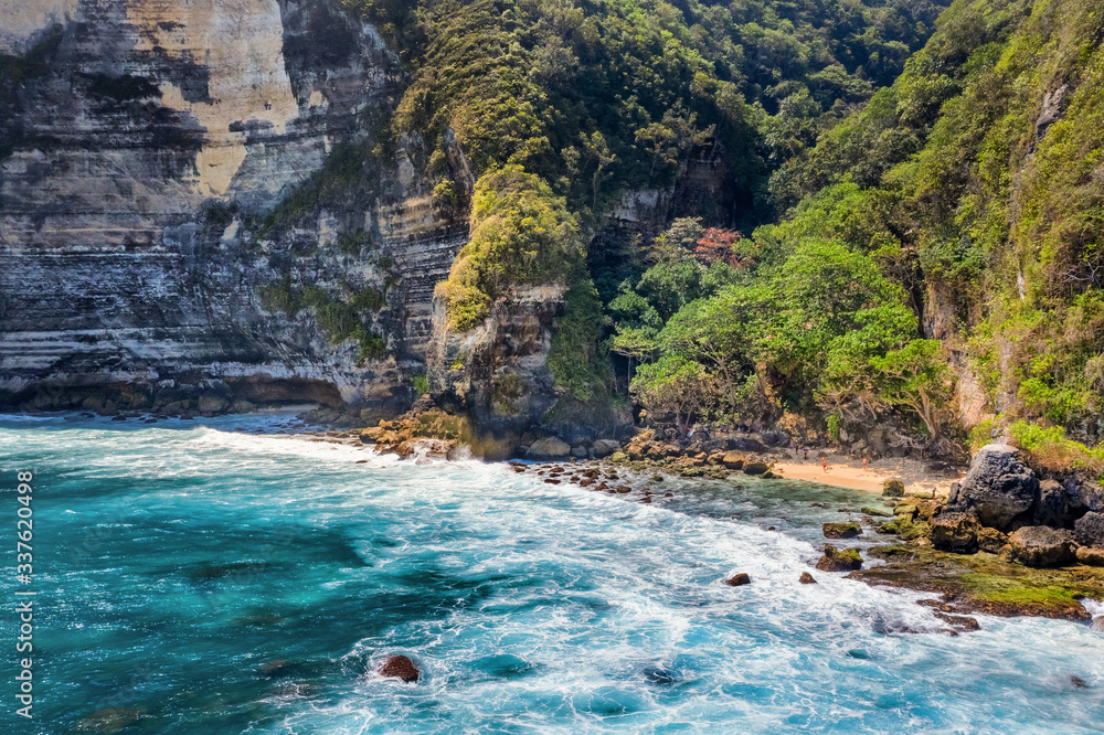 Magnificent view of unique natural rocks and cliffs formation in beautiful beach known as Atuh Beach located in the east side of Nusa Penida Island, Bali, Indonesia. Aerial view. Magnificent view of unique natural rocks and cliffs formation in beautiful beach known as Atuh Beach located in the east side of Nusa Penida Island, Bali, Indonesia. Aerial view.