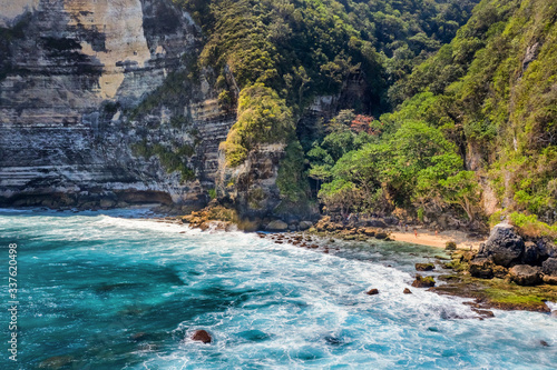 Magnificent view of unique natural rocks and cliffs formation in beautiful beach known as Atuh Beach located in the east side of Nusa Penida Island, Bali, Indonesia. Aerial view. © Hien Phung