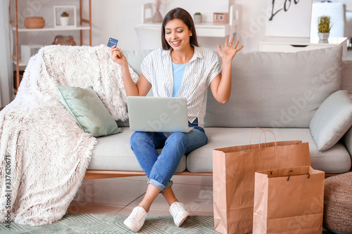 Young woman with laptop and...