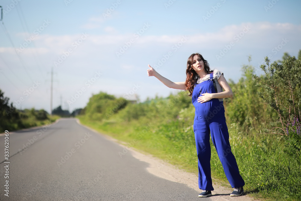 Pregnant woman on the road stops the car