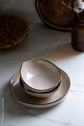 Brown rustic handmade kitchenware on white background. Ceramic dished in neutral tones, scandinavian style.