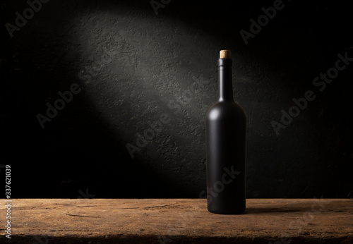 Wine bottles with glass, wooden background border