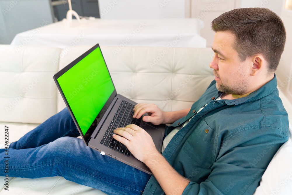 chromakey. blogger working online lying on couch.