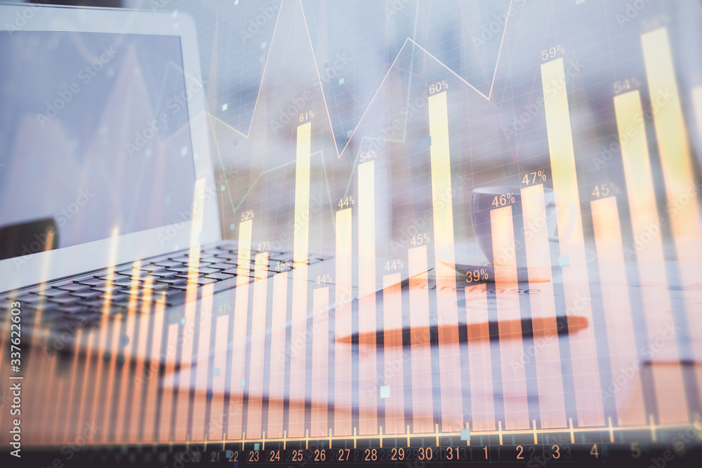 Forex graph hologram on table with computer background. Double exposure. Concept of financial markets. Forex graph hologram on table with computer background. Double exposure. Concept of financial markets.