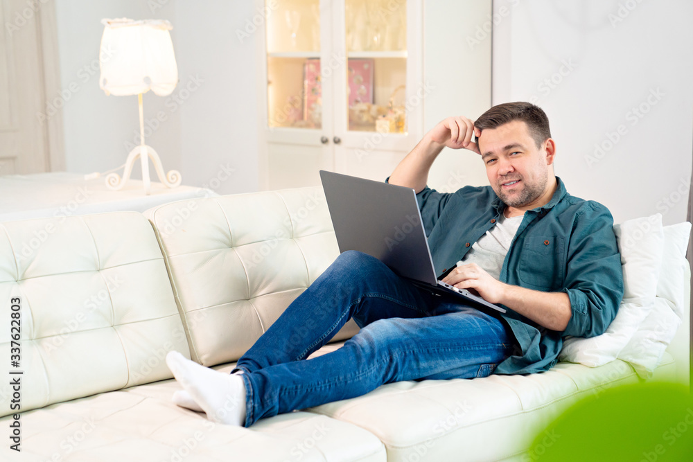 happy blogger working lying on couch. quarantine happy blogger working lying on couch. quarantine