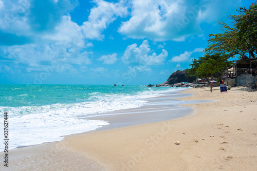 Fototapeta Naklejka Na Ścianę i Meble -  Gorgeous tropical sandy beach with palm trees, blue sky and clear water.