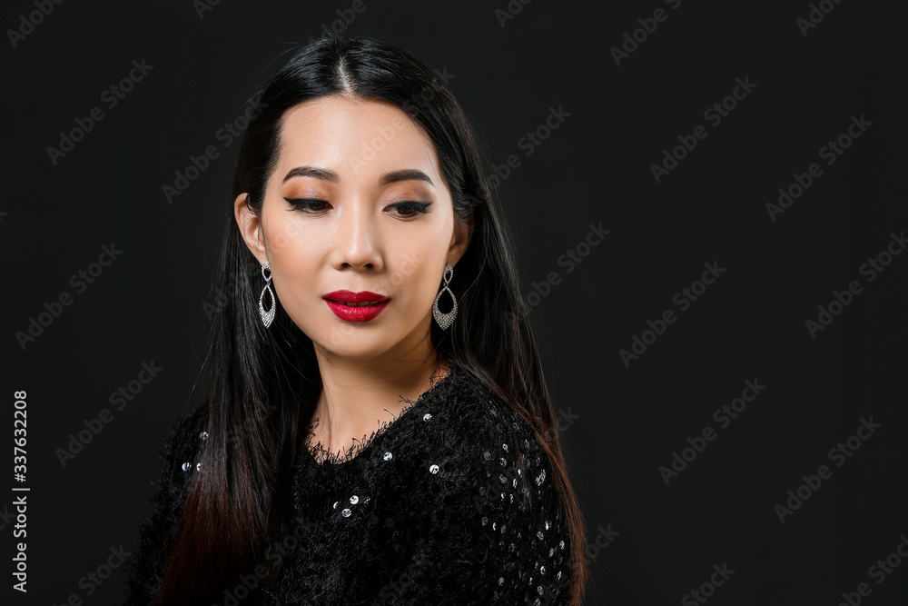 Young Asian woman with beautiful hair on dark background Young Asian woman with beautiful hair on dark background