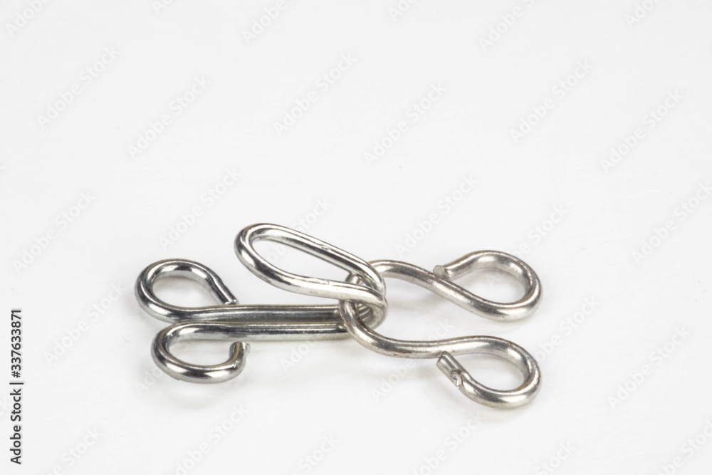 Close up macro of a dress making hook and eye isolated on a white background Close up macro of a dress making hook and eye isolated on a white background