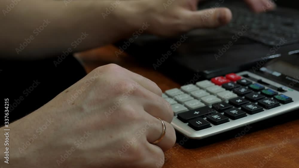 The head of the family reduces the debit with the loan for the past year, counts on a calculator and enters the data into the computer, fills the tax form. The head of the family reduces the debit with the loan for the past year, counts on a calculator and enters the data into the computer, fills the tax form.