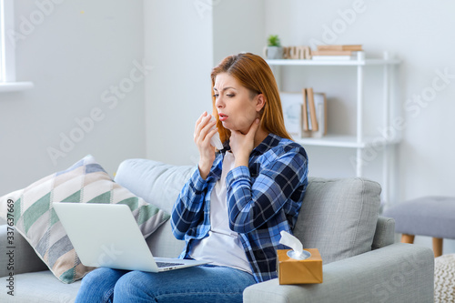 Sick woman with laptop at home