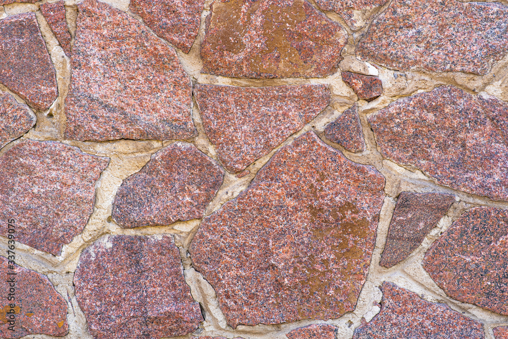 The texture of the stone wall. The wall of a large old house. The texture of the stone wall. The wall of a large old house.