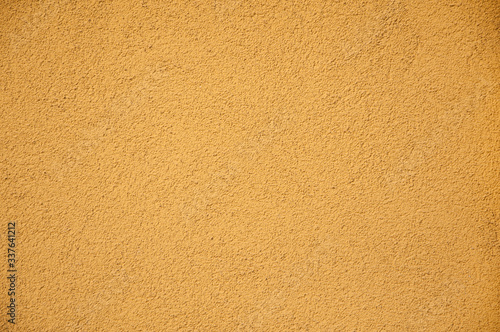 yellow mastic on the wall background texture natural