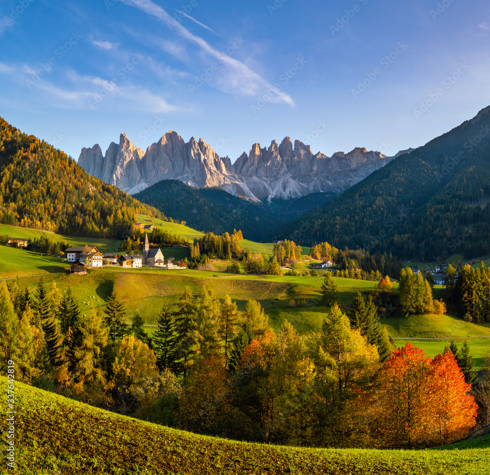 Autumn evening Santa Magdalena famous Italy Dolomites village view in front of the Geisler or Odle Dolomites mountain rocks.